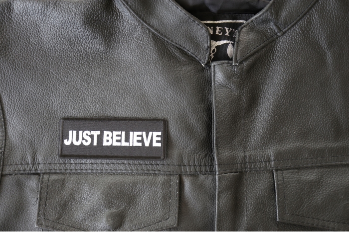 Just Believe Patch - 4x1.5 inch - Embroidered Iron on Patch shown on leather vest