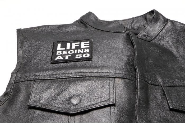 Life Begins at 50 Patch - 3x2 inch. Embroidered Iron on Patch shown on leather vest