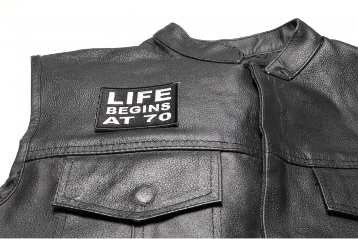 Life Begins at 70 Patch - 3x2 inch. Embroidered Iron on Patch shown on leather vest