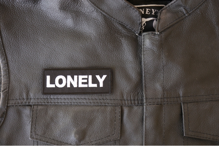 Lonely Patch - 4x1.5 inch - Embroidered Iron on Patch shown on leather vest