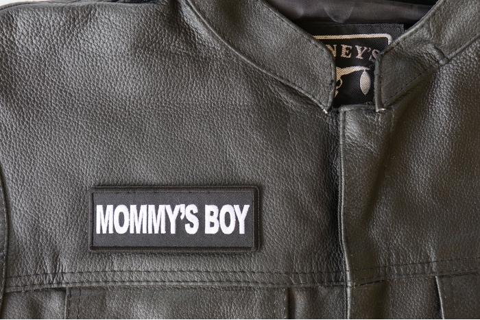 Mommy's Boy Patch - 4x1.5 inch - Embroidered Iron on Patch shown on leather vest