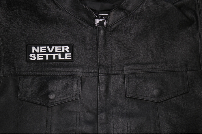 Never Settle Patch shown on leather vest