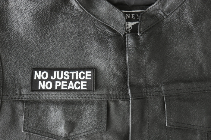 No Justice No Peace Patch - 4x1.5 inch - Embroidered Iron on Patch shown on leather vest