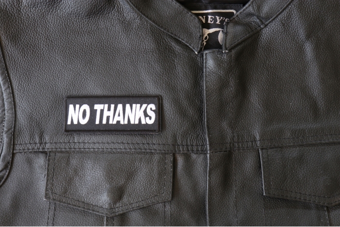No Thanks Patch - 4x1.5 inch - Embroidered Iron on Patch shown on leather vest