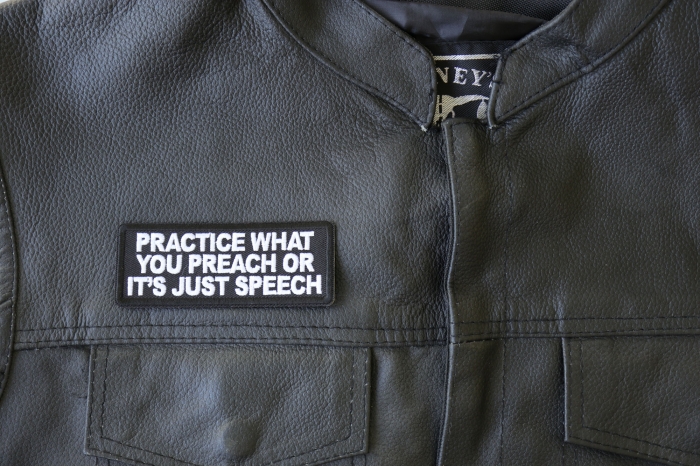 Practice What You Preach or It's Just Speech Patch - 4x1.5 inch - Embroidered Iron on Patch shown on leather vest