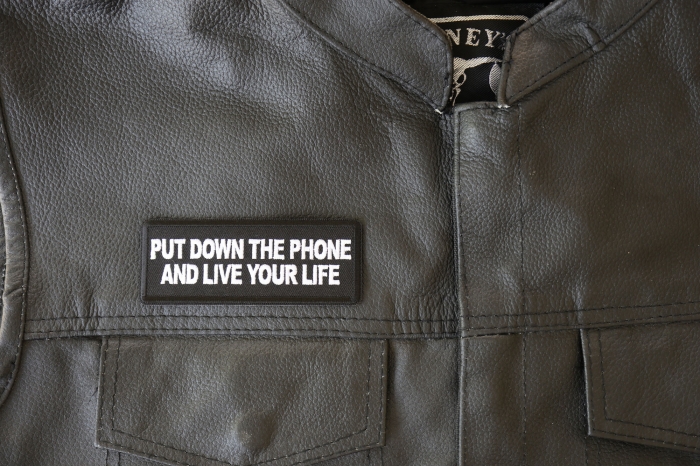 Put Down the Phone and Live Your Life Patch - 4x1.5 inch - Embroidered Iron on Patch shown on leather vest