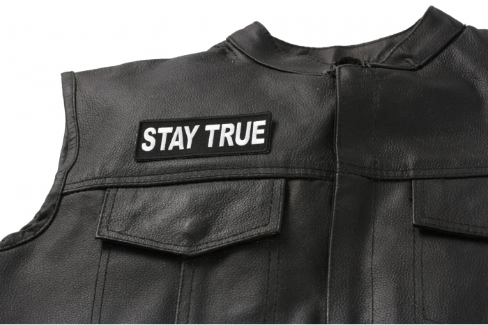 Stay True Patch - 4x1.5 inch. Embroidered Iron on Patch shown on leather vest