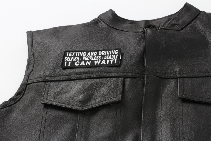 Texting and Driving Selfish Reckless Deadly It Can Wait Patch - 4x1.5 inch. Embroidered Iron on Patch shown on leather vest