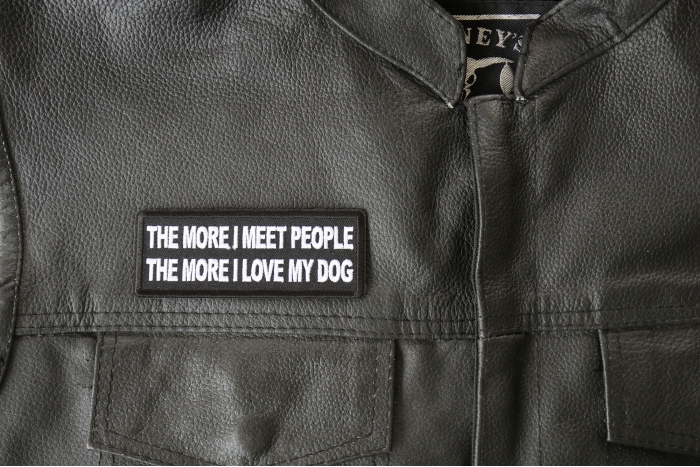 The More I meet People The More I love My Dog - 4x1.5 inch - Embroidered Iron on Patch shown on leather vest