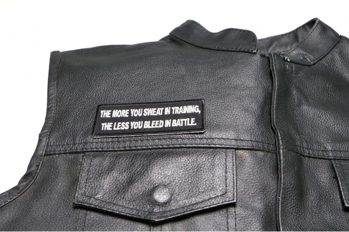 The More You Sweat In Training, The Less You Bleed in  Battle Patch, Military Saying Patches shown on leather vest