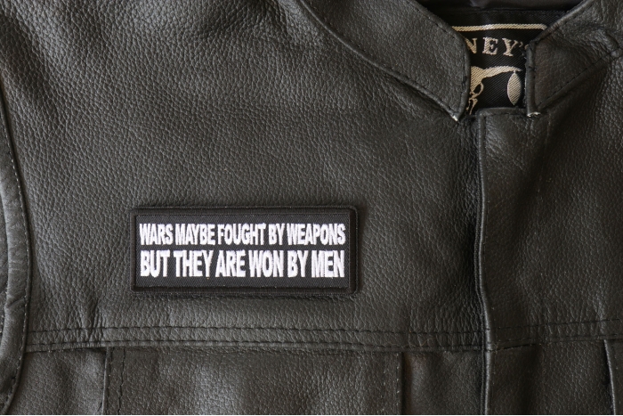 Wars Maybe fought by weapons but they are won my Men Patch - 4x1.5 inch - Embroidered Iron on Patch shown on leather vest