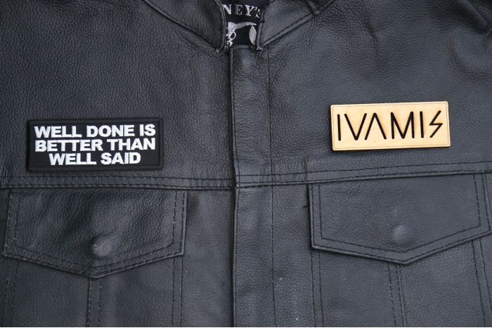 Well Done is Better Than Well Said Patch shown on leather vest