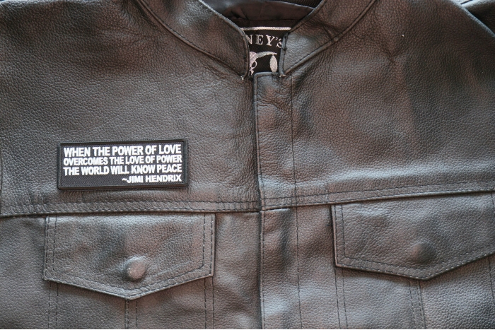When The Power Of Love Overcomes the Love of Power The World Will Know Peace Patch shown on leather vest