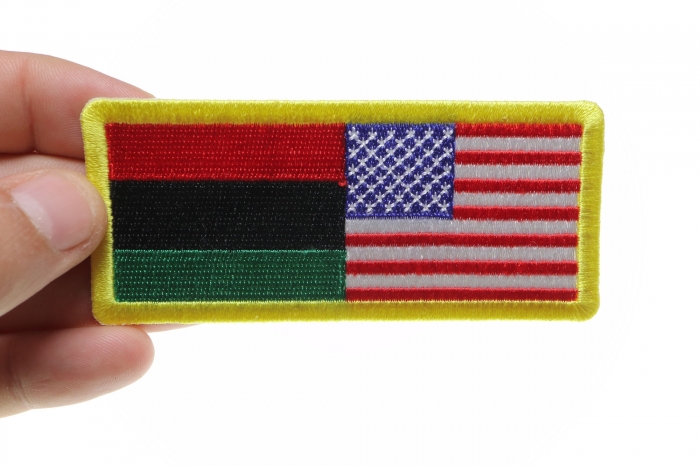 African American Flag Patch shown on hand for size comparison