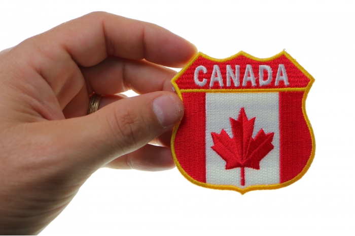 Canadian Shield Patch - Canada Flag shown on hand for size comparison
