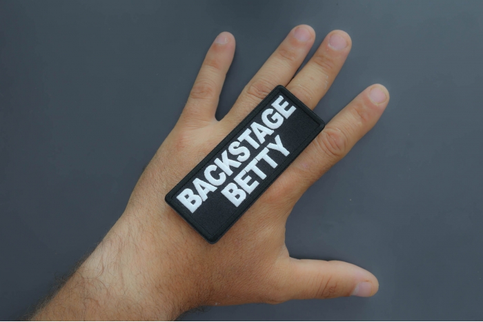 Backstage Betty Patch shown on hand for size comparison