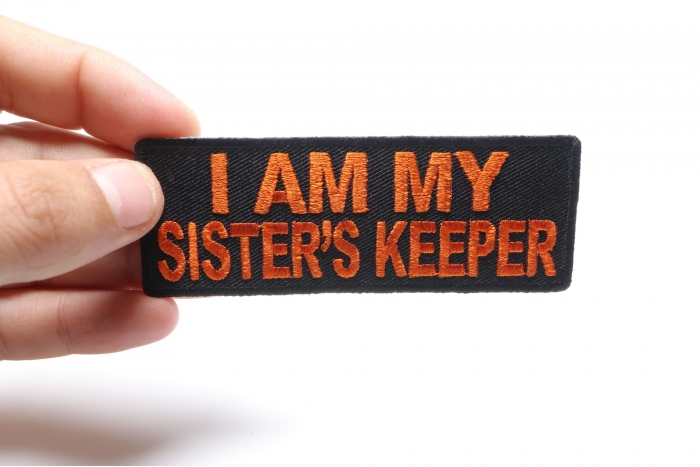 I am my Sister's Keeper Patch in Orange shown on hand for size comparison