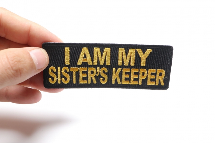 I am my Sister's Keeper Patch in Yellow shown on hand for size comparison