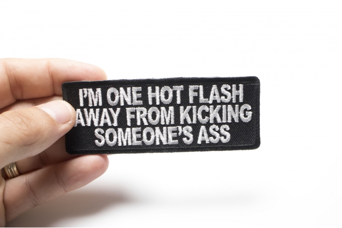 I'm One Hot Flash Away From Kicking Someone's Ass Patch shown on hand for size comparison