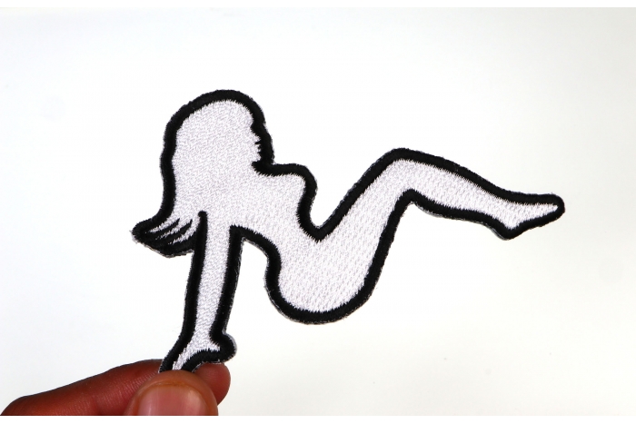 MudFlap Girl Patch In White Facing Right shown on hand for size comparison
