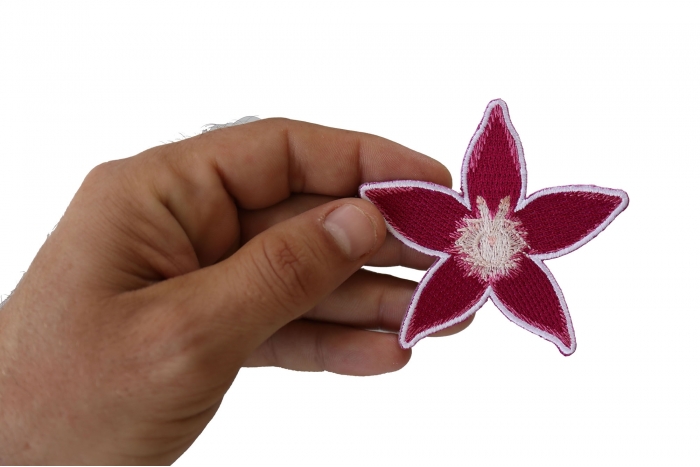 Pink Flower Iron on Patch shown on hand for size comparison