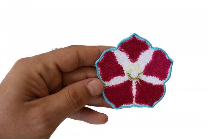 Pink White Flower Iron on Patch shown on hand for size comparison