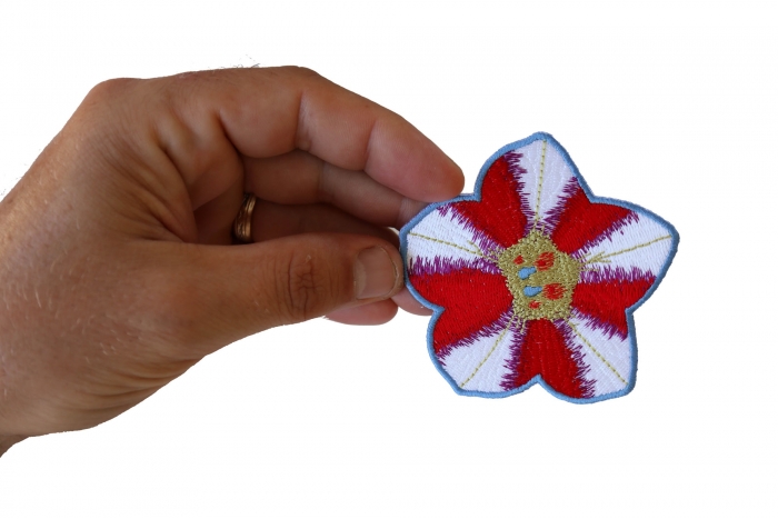 Pink White Flower Iron on Patch shown on hand for size comparison
