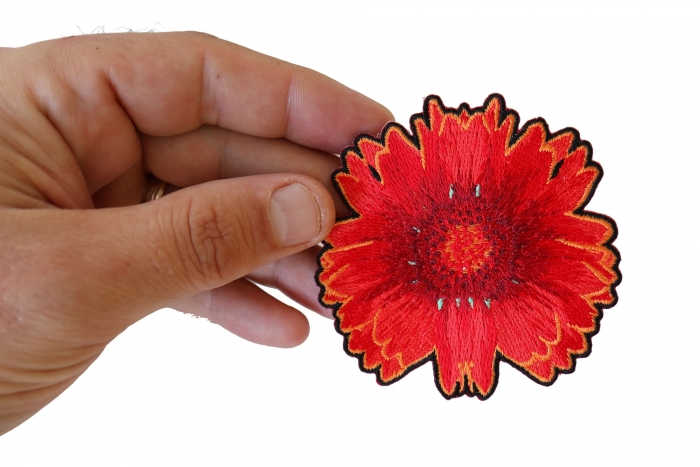 Red Orange Flower Iron on Patch shown on hand for size comparison