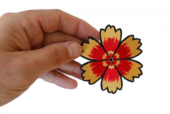 Red Yellow Flower Iron on Patch shown on hand for size comparison