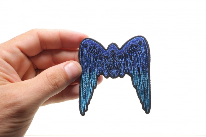 Small Angel Wings Biker Patch Blue shown on hand for size comparison
