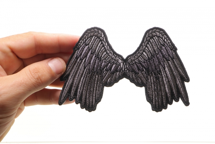 Small Beautiful Angel Wings Grey Biker Patch shown on hand for size comparison