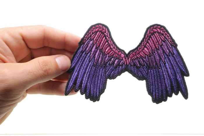 Small Beautiful Angel Wings Pink Biker Patch shown on hand for size comparison