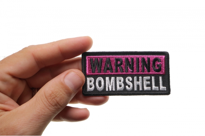 Warning Bombshell Patch shown on hand for size comparison