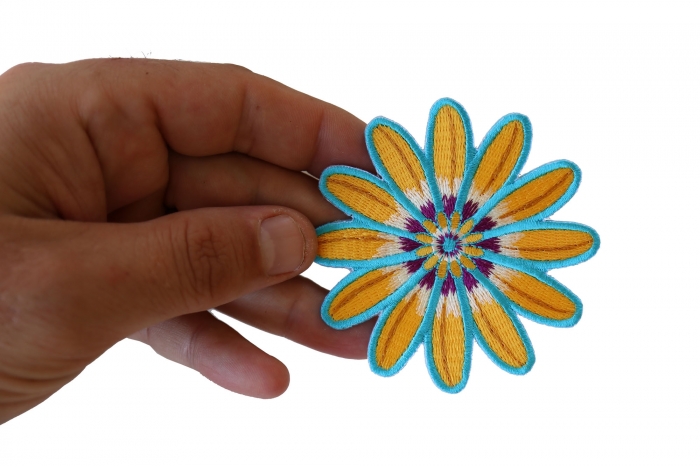 Yellow Blue Flower Patch shown on hand for size comparison