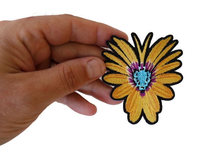 Yellow Flower Butterfly Iron on Patch shown on hand for size comparison