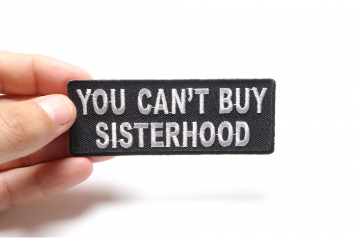 You Can't Buy Sisterhood Patch shown on hand for size comparison