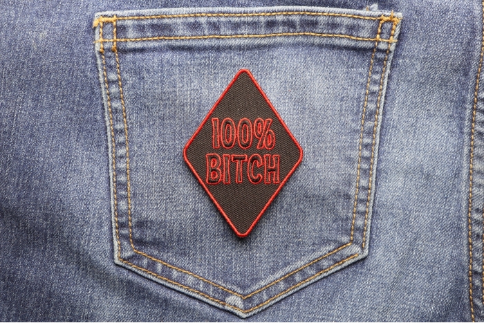 100 Percent Bitch Patch shown on jeans