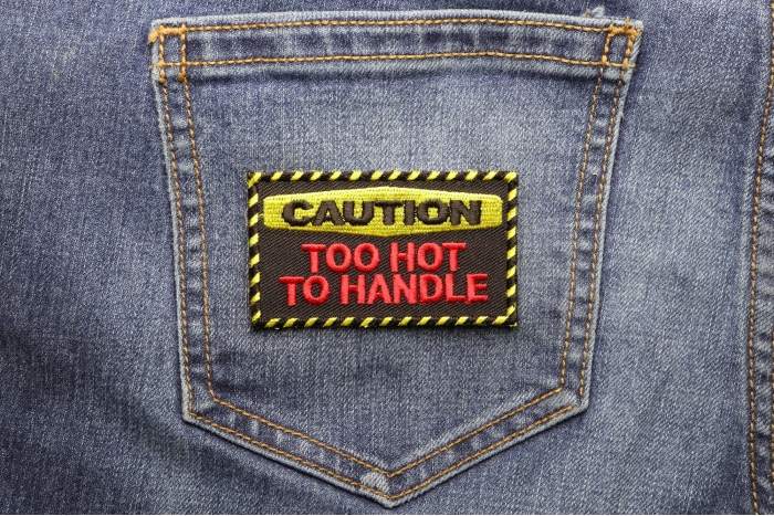 Caution Too Hot To Handle Patch shown on jeans