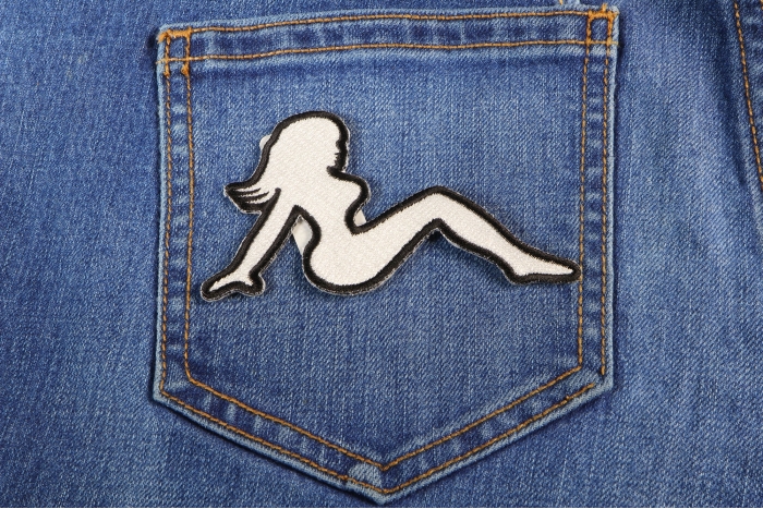 MudFlap Girl Patch In White Facing Right shown on jeans