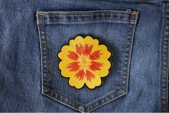Orange Yellow Flower Iron on Patch shown on jeans
