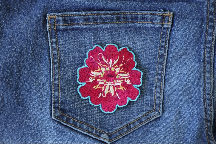 Pink Flower Iron on Patch shown on jeans