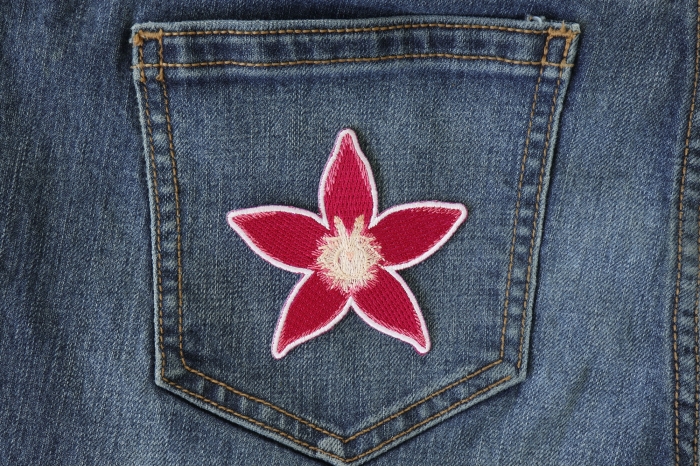 Pink Flower Iron on Patch shown on jeans
