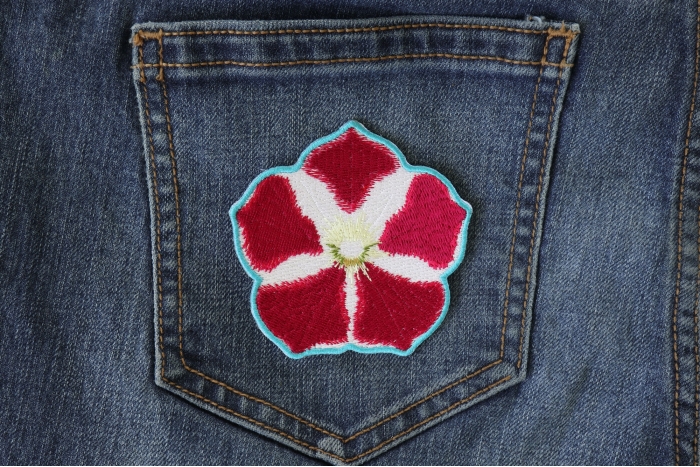 Pink White Flower Iron on Patch shown on jeans
