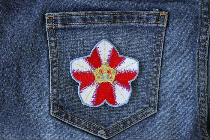 Pink White Flower Iron on Patch shown on jeans