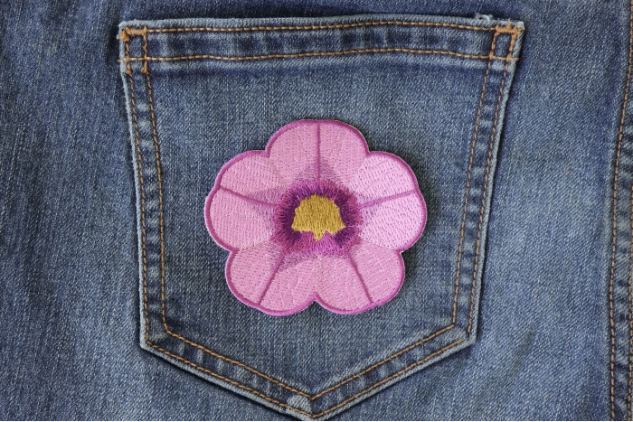 Purple Flower Iron on Patch shown on jeans