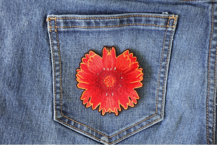 Red Orange Flower Iron on Patch shown on jeans