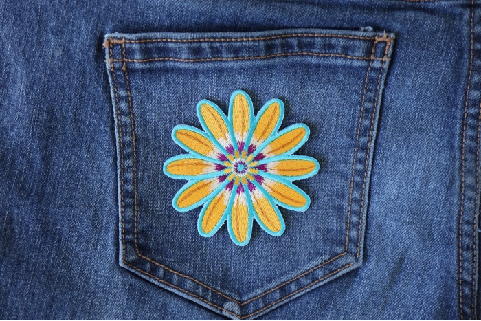 Yellow Blue Flower Patch shown on jeans