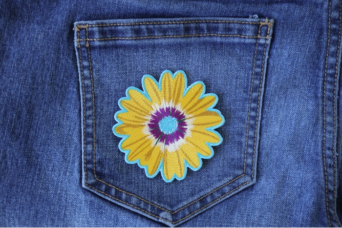 Yellow Blue Pink Flower Patch shown on jeans