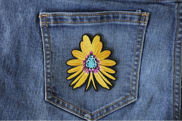 Yellow Flower Butterfly Iron on Patch shown on jeans