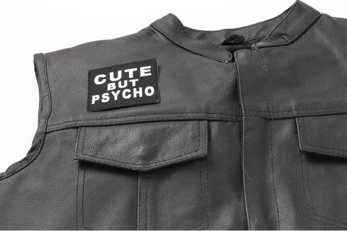 Cute But Psycho Patch - 3x2.75 inch. Embroidered Iron on Patch shown on leather vest